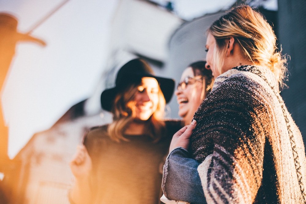 group of people laughing in the sunlight