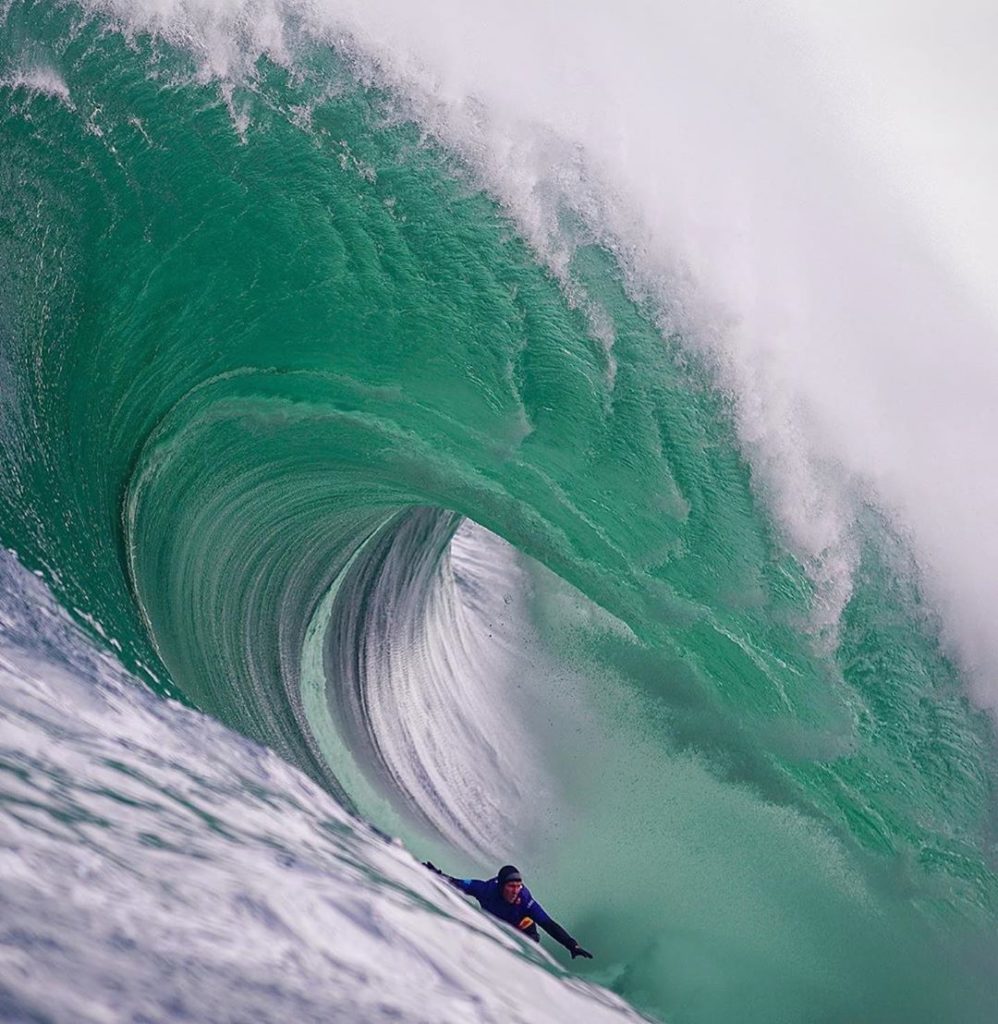 from the water image of andrew riding a big wave